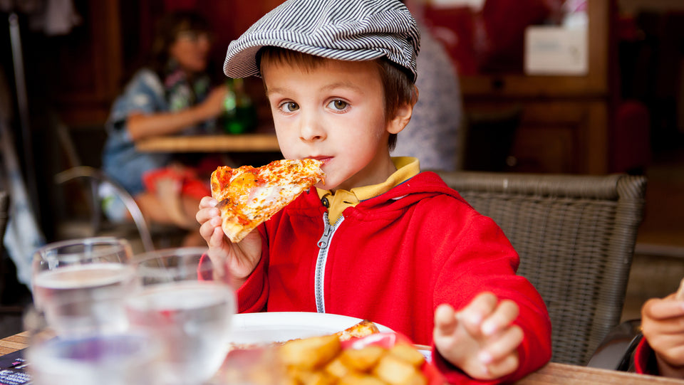 Little boy tasting pizza